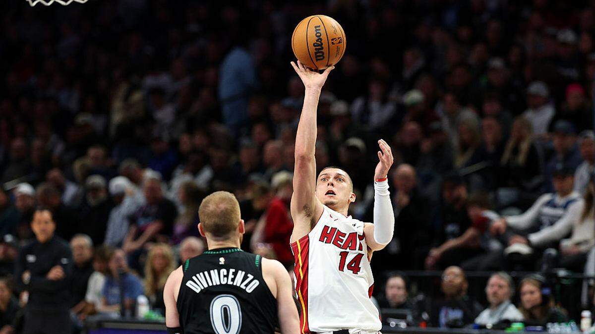Tyler Herro #14 of the Miami Heat shoots the ball against Donte Divincenzo #0 of the Minnesota Timberwolves in the third quarter at Target Center on January 06, 2026 in Minneapolis, Minnesota.