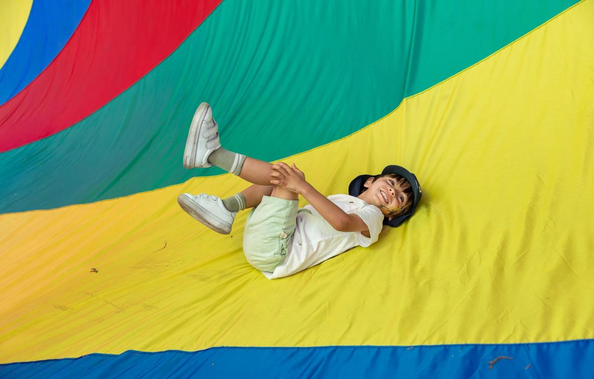 Josiah Pereira, 4, plays inside of a 100-foot spin sock on display at the 33rd Annual Kite Festival in Northeast Miami-Dade on Saturday, Feb. 15, 2025.