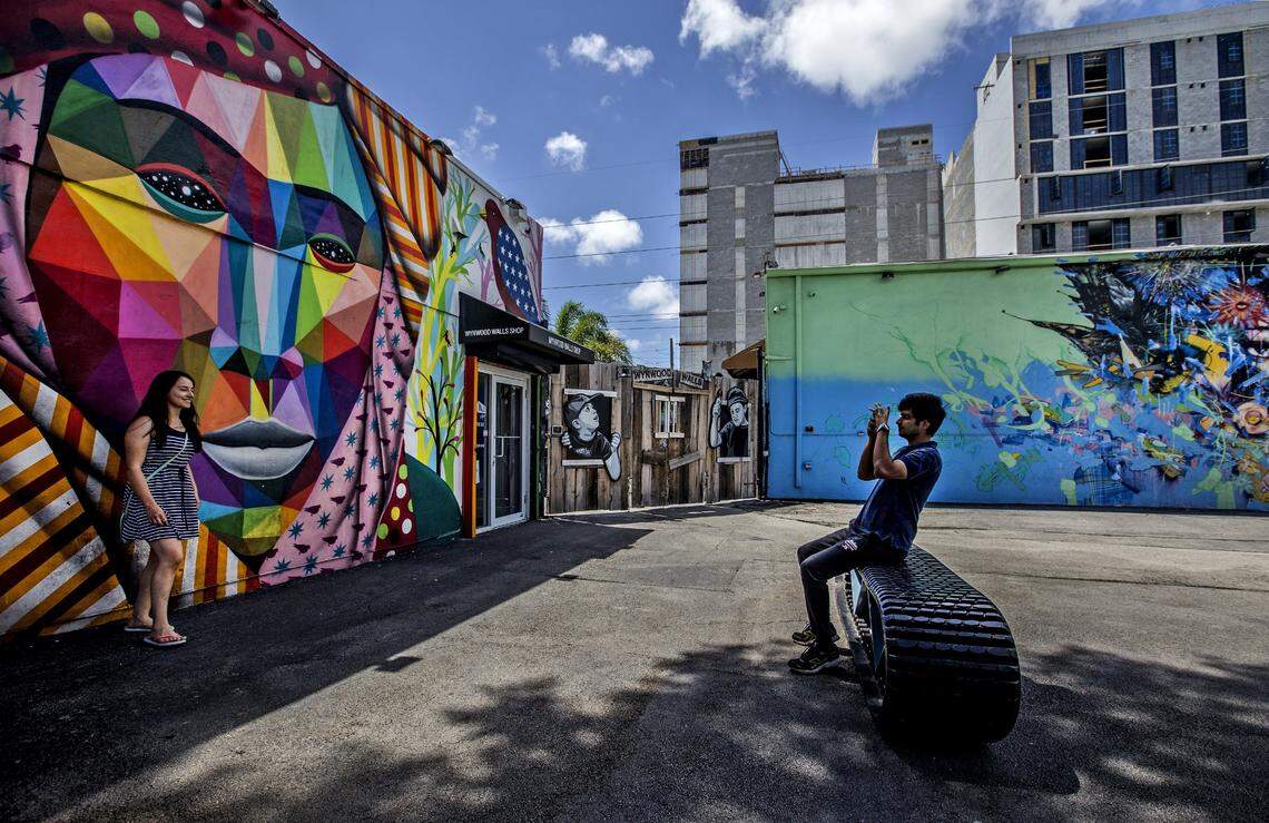 Visitors take pictures of the colorful murals at Wynwood Walls on Thursday August 2, 2018. To the south, construction continues on Wynwood Annex, a new office building, and the adjacent Wynwood 25, which will bring 289 apartment rentals to the neighborhood.