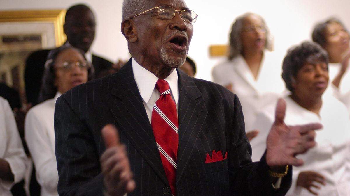 Bishop Walter H. Richardson, center, joins the Tabernacle Gospel Inspirational Choir in a song during a Sunday morning service at The Church of God Tabernacle in Liberty City on May 20, 2007.