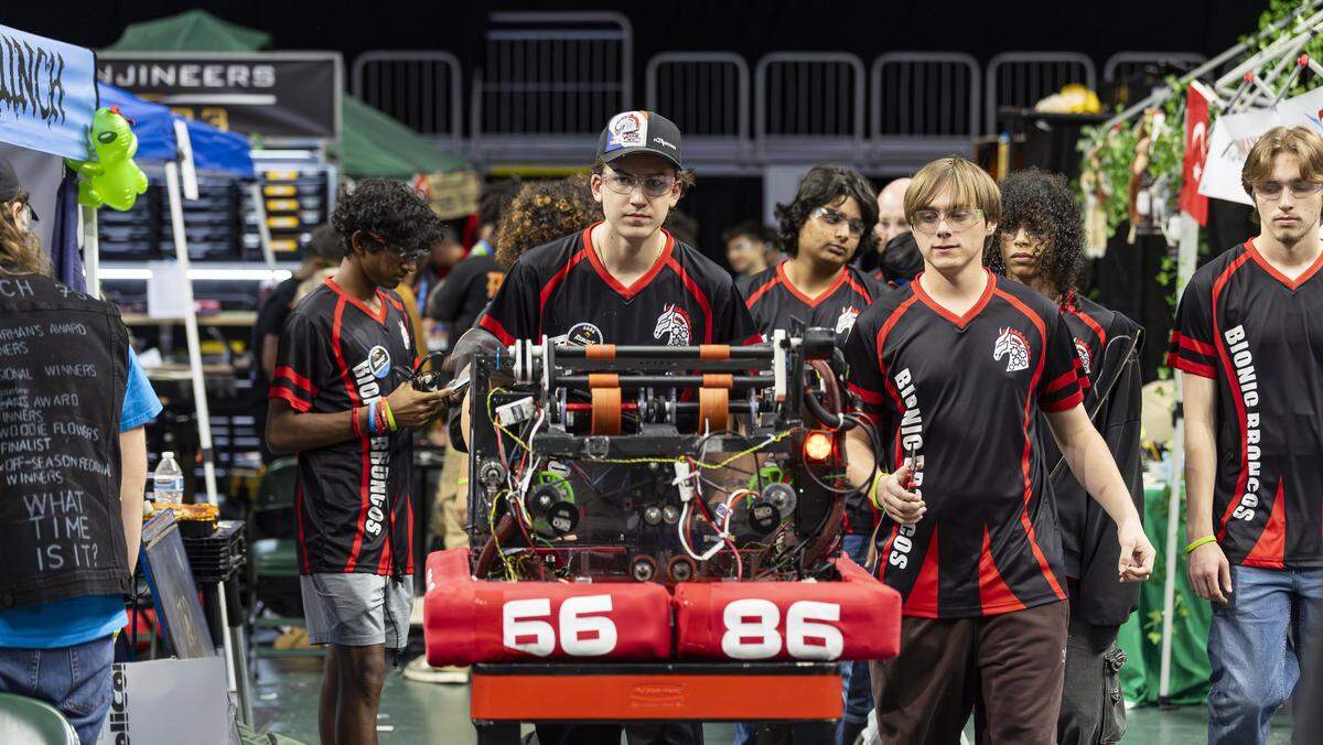 Palm Beach Central High School student Riley McLaughlin, 15, a member of the Bionic Broncos, pushes his team’s robot, Bucky Barnes, as he and his team compete in the 2026 FIRST Robotics South Florida Regional Competition at the University of Miami’s Watsco Center on Friday, April 10, 2026, in Coral Gables, Fla. Participants from local school districts, surrounding states, and international teams are competing for an opportunity to earn a spot at the 2026 FIRST World Championship.
