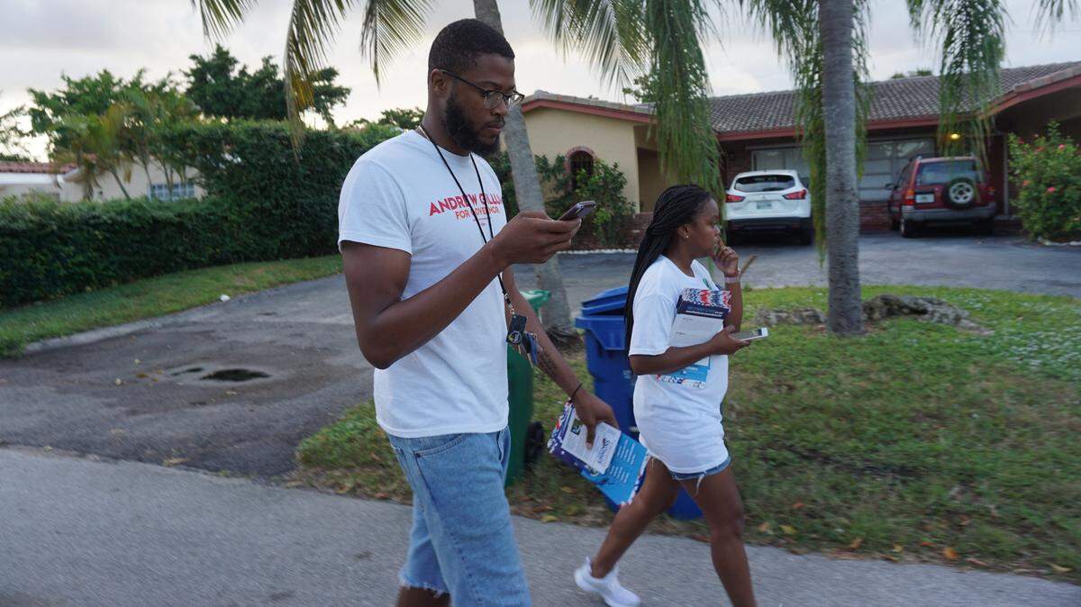 Asa Rogers-Shaw, a community organizer for the New Florida Majority and Nesha Miller, a palm beach county elementary school teacher, canvassing in Coral Springs on Nov. 5. Rogers-Shaw created the #1000DoorChallenge, where he knocks on the doors of 1000 inactive voters, to encourage people to vote during Florida’s mid-year elections.