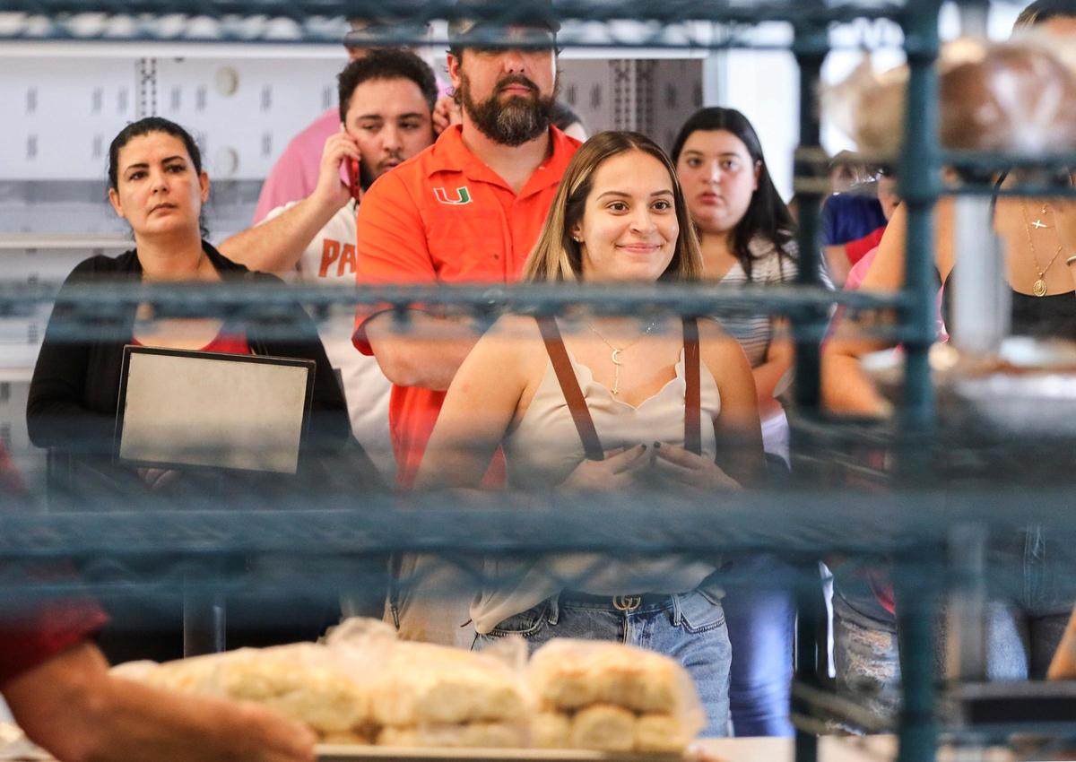 After more than three hours of waiting, customers are finally in sight of the counter to order hot cinnamon rolls at Knaus Berry Farm, which opened for the season Tuesday, Oct. 29, 2019, in the Redland in south Miami-Dade. People flock to the farm for fresh baked goods, shakes and the fresh fruits and vegetables, which are grown on the farm.