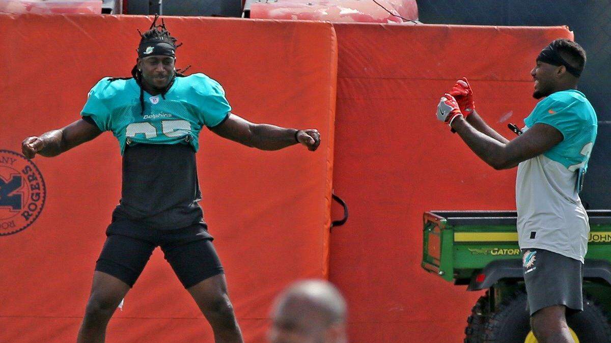 Miami Dolphins DB Walt Aikens (35) dances to the music during warm ups as Cordrea tankersley (23) watches at their training facility in Davie, Florida, September 26, 2018.