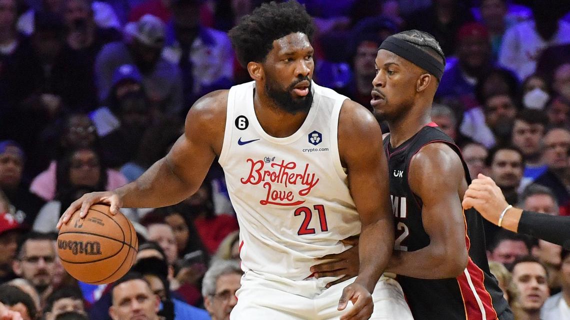 Philadelphia 76ers center Joel Embiid (21) is defended by Miami Heat forward Jimmy Butler (22) during the second quarter at Wells Fargo Center.