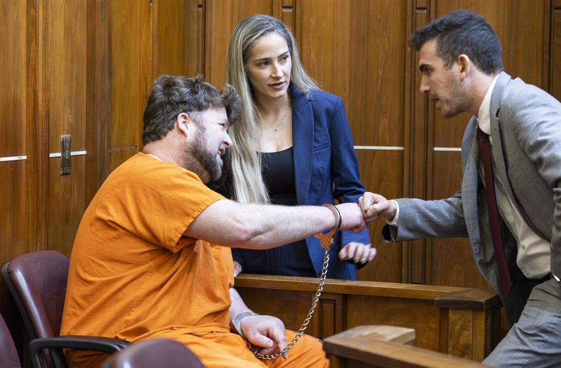 Travis Grafe, son of the former Knaus Berry Farms owners, is flanked by his attorneys Lauren Dawson and Adam Peters while attending court for a competency hearing at the Richard E. Gerstein Justice Building on Friday, Sept. 26, 2025, in Miami, Fla. He is accused of beating his mother, Rachel Knaus Grafe, to death.