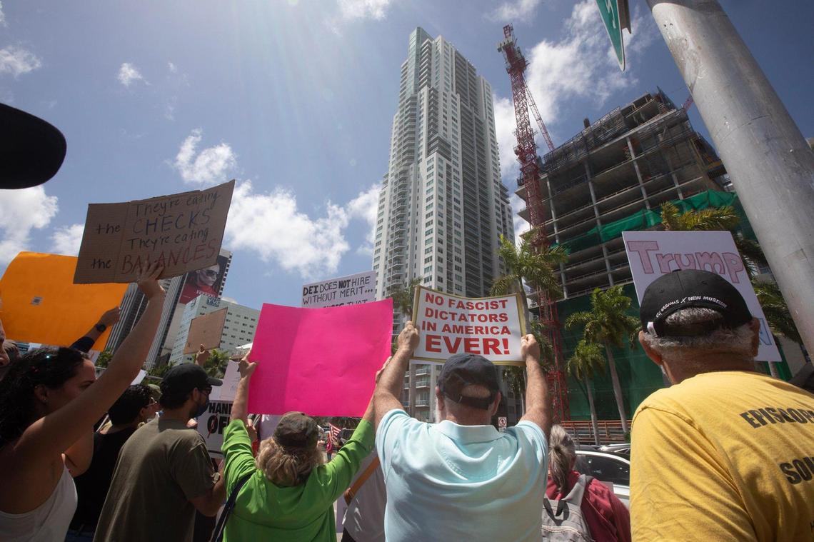 Protesters gather at the Torch of Friendship in Miami, Florida, on Saturday, April 5, 2025, during the ‘Hands Off! Miami Fights Back’ demonstration, opposing the policies of President Donald Trump and his Senior Advisor, Elon Musk.
