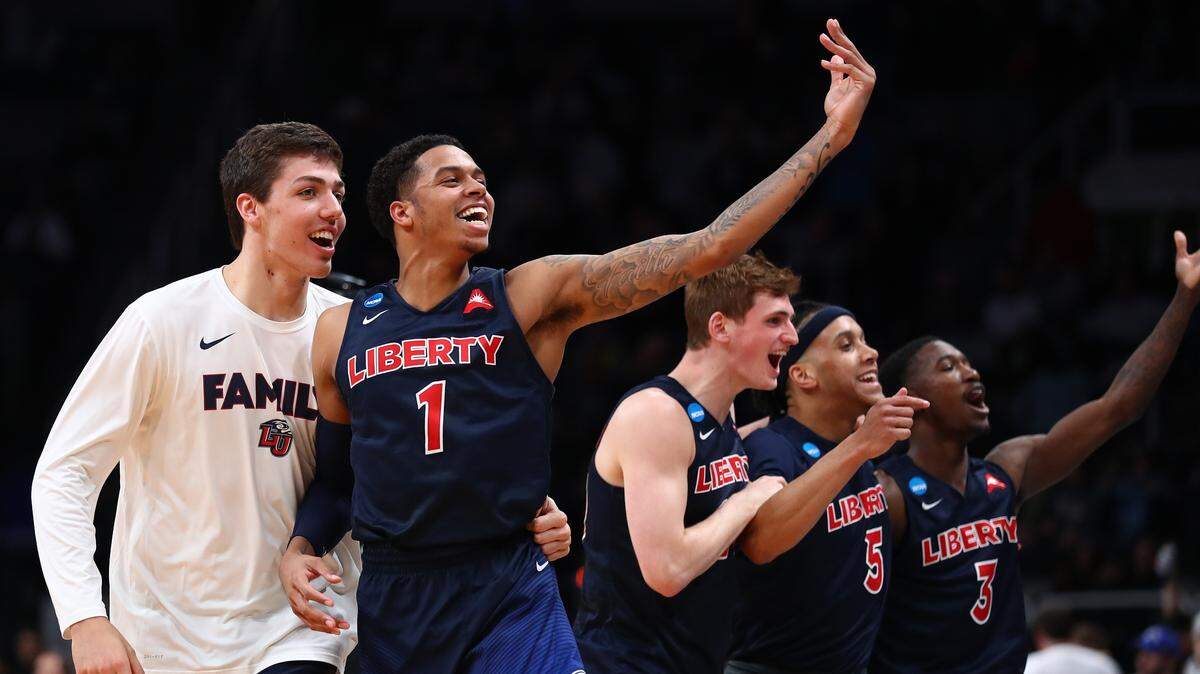 Caleb Homesley #1 and the Liberty Flames celebrate their 80-76 win over the Mississippi State Bulldogs during their game in the First Round of the NCAA Basketball Tournament at SAP Center on March 22, 2019 in San Jose, California.