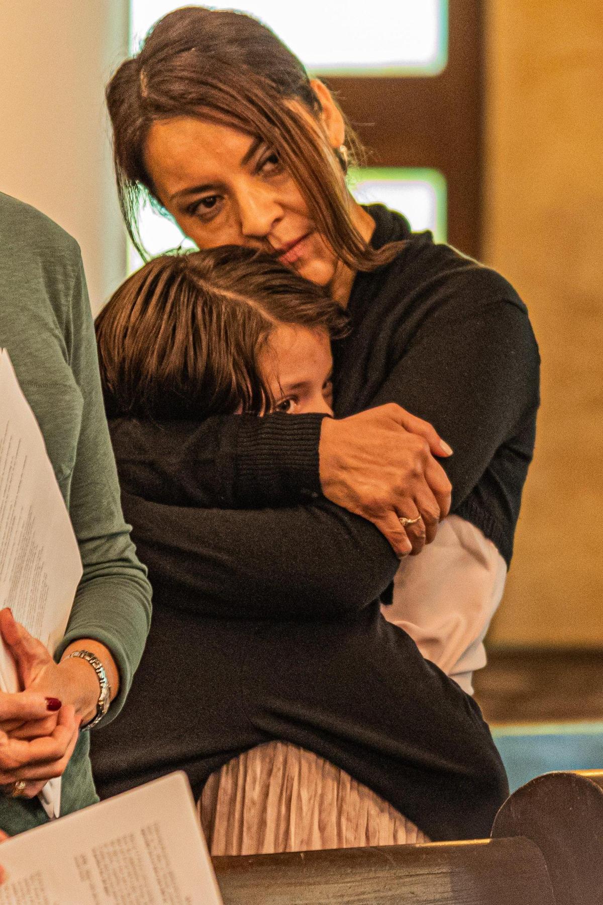 People hug during “An Interfaith Service of Remembrance, Hope, and Peace” on the 21st anniversary of 9/11 at Coral Gables Congregational United Church of Christ in Coral Gables, Fla. on Sept. 11, 2022.