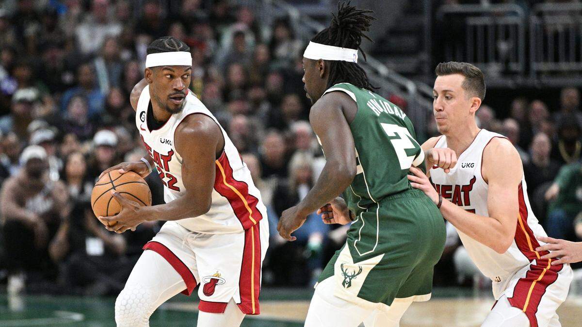 Miami Heat forward Jimmy Butler (22) drives against Milwaukee Bucks guard Jrue Holiday (21) during game five of the 2023 NBA Playoffs at Fiserv Forum.