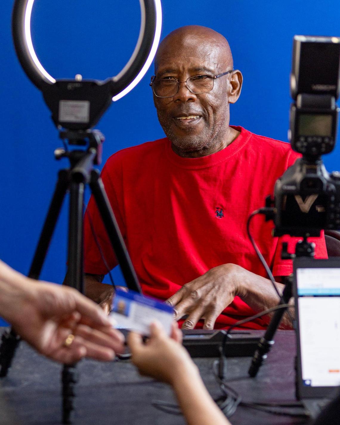 Pompano Beach resident Maurice F. Middleton, 68, looks on as staff prepare his new Broward County ID card during a community ID event hosted by Legal Aid Service of Broward County in partnership with Salvation Army in Fort Lauderdale, Florida, on Friday, August 18, 2023.