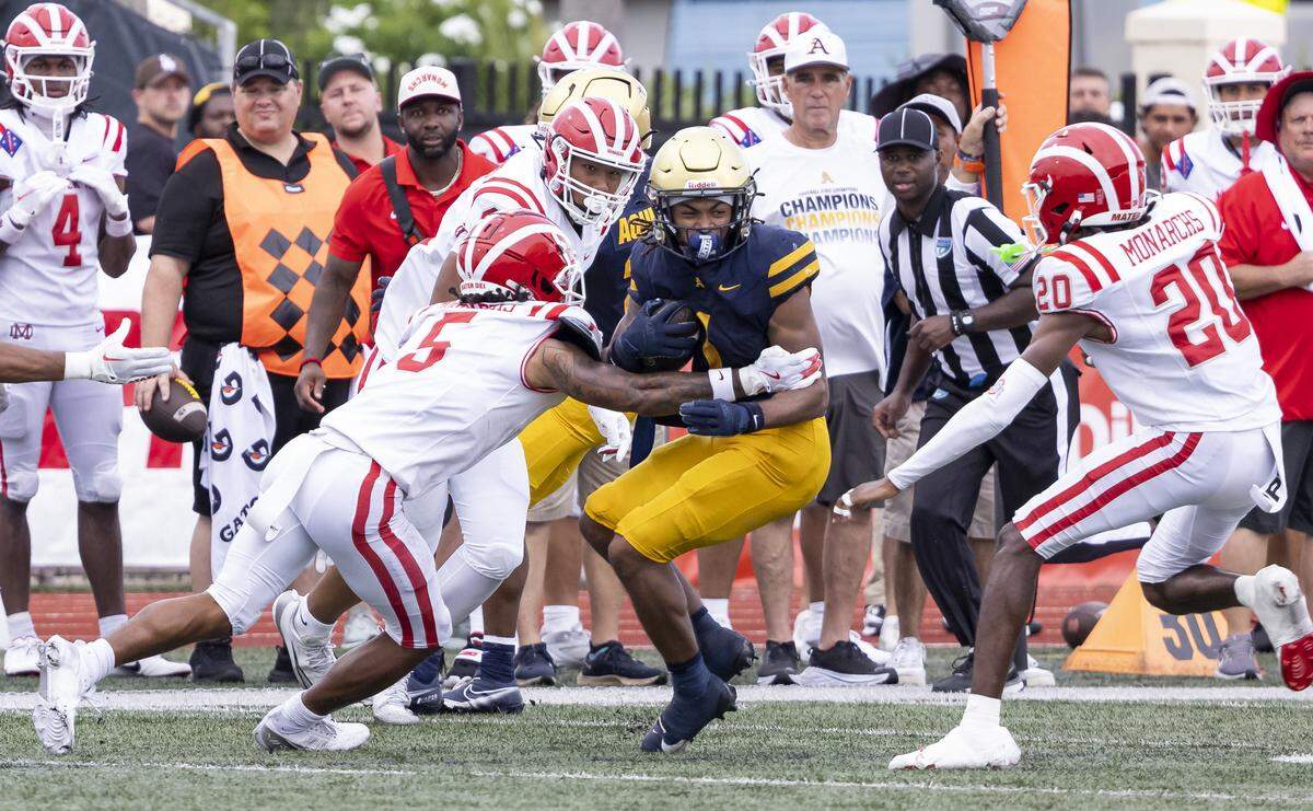 St. Thomas Aquinas Raiders defensive back Jermiyah Douglas (1) is tackled by Mater Dei Monarchs defensive back CJ Lavender, Jr. (5) in the first half of their football game at St.Thomas Aquinas High School on Saturday, Aug. 23, 2025, in Fort Lauderdale, Fla.
