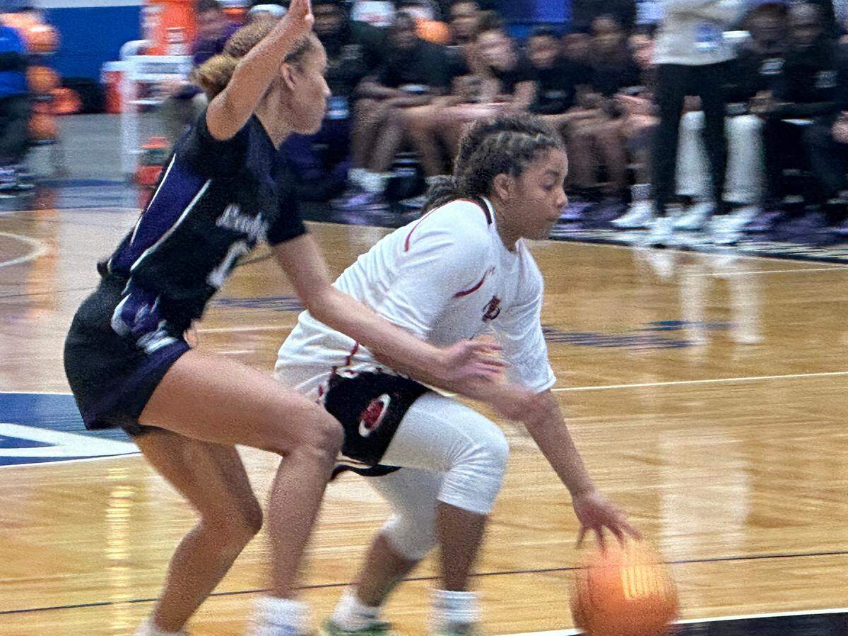 Northeast guard Jazmine Jones (right) drives to the basket while defended by Gainesville’s Jayden Terry (left) during a Class 5A state girls’ basketball semifinal on Wednesday at the RP Funding Center in Lakeland, Fla.