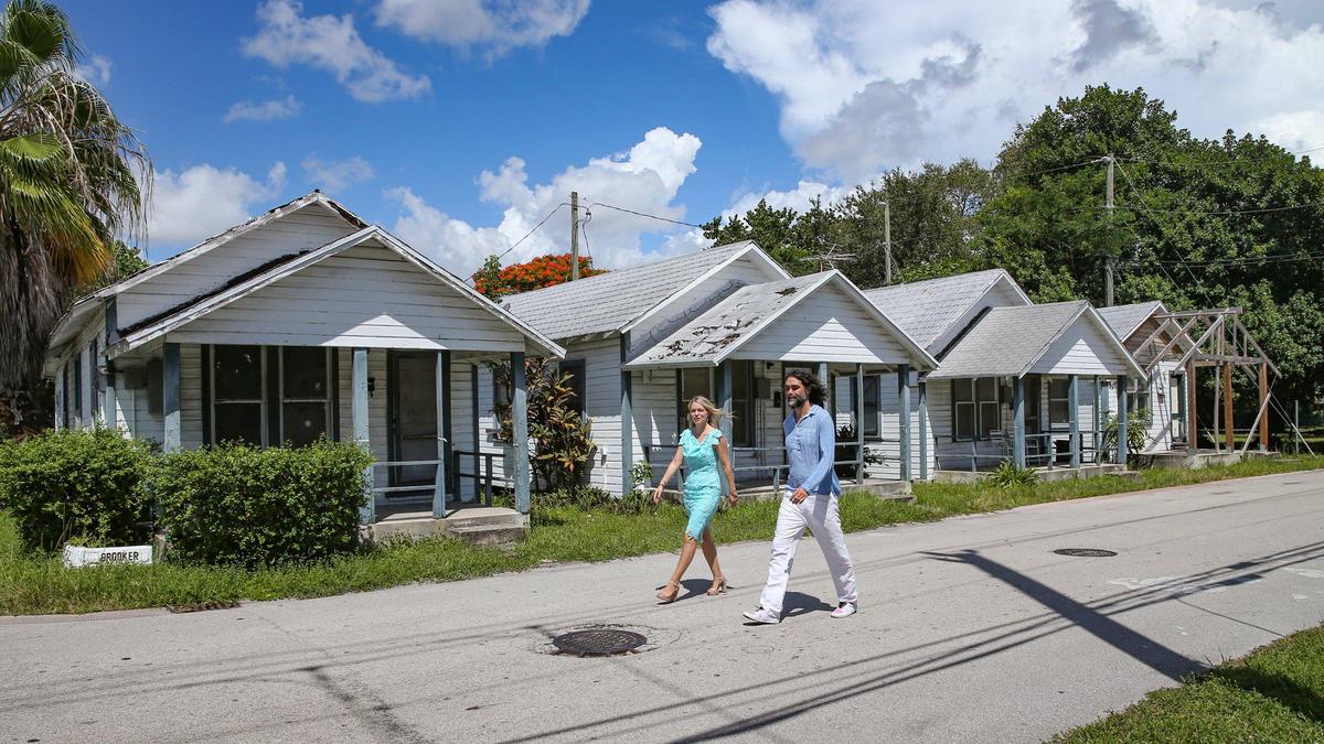 Admirer of Coconut Grove history Fabio Riberio walks on Sept. 1, 2022 with real estate agent Kathrin Rein. Riberio, a native of Brazil, is the new owner of four historic homes nearby in the MacFarlane Homestead Historic District.