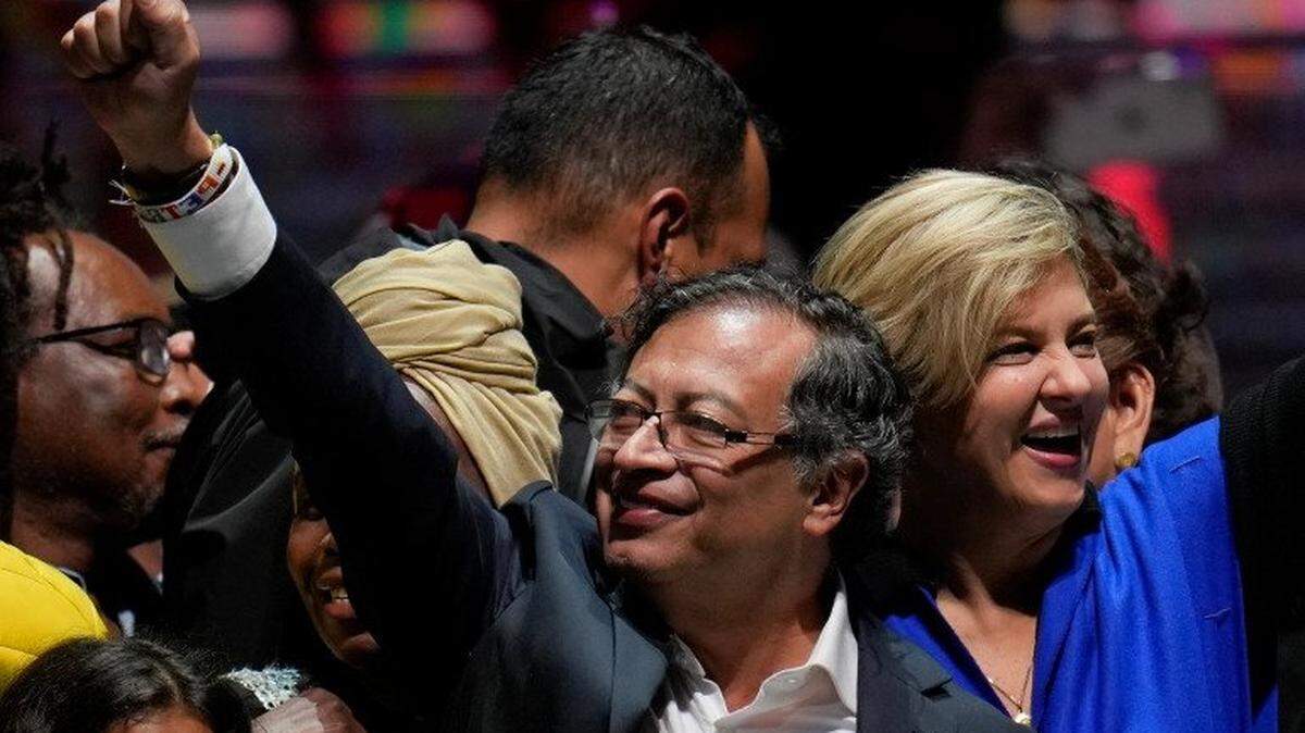 Former rebel Gustavo Petro and his wife, Veronica Alcocer, celebrate before supporters after winning a June 19 runoff presidential election in Bogotá, Colombia.