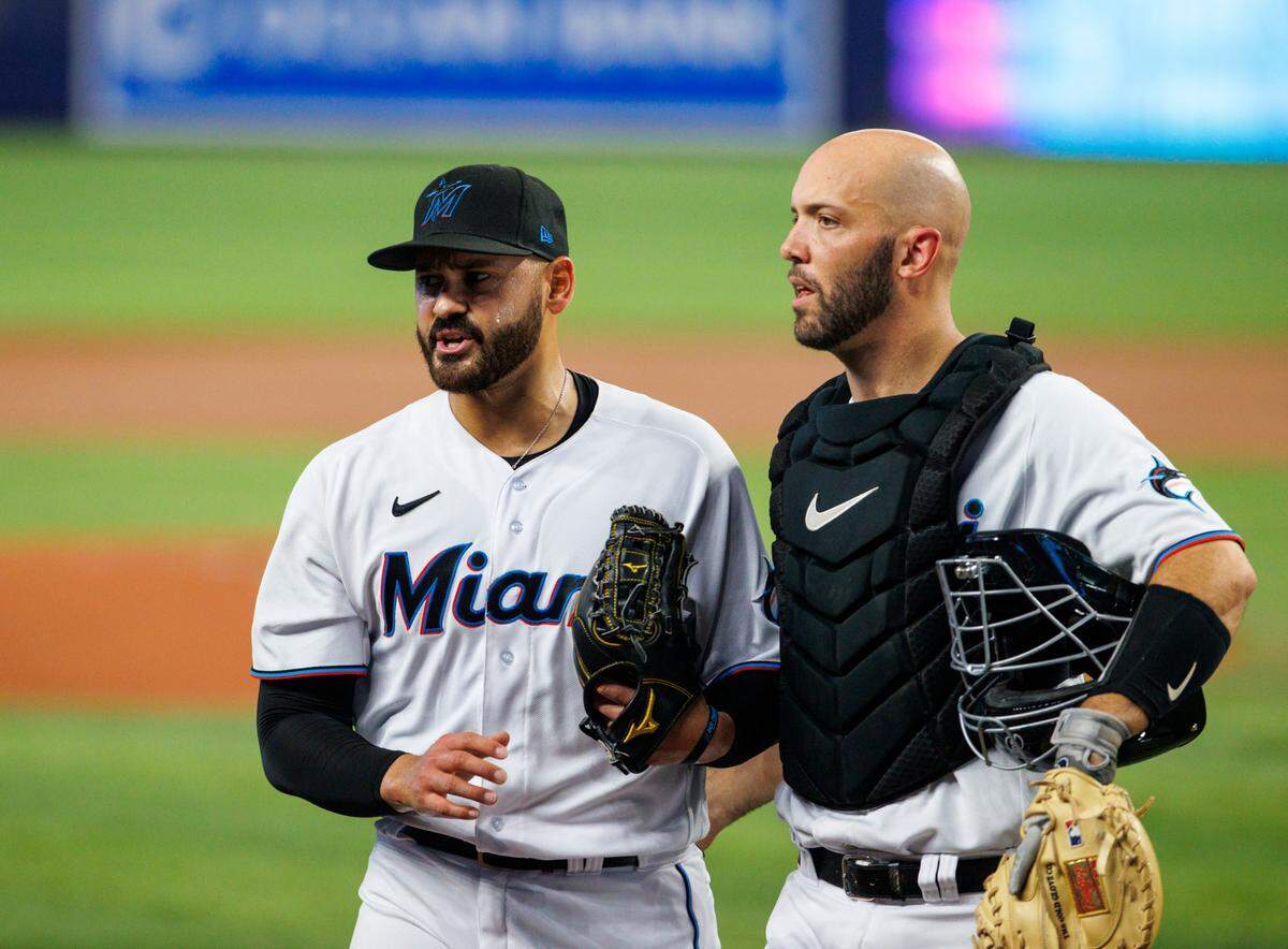 Miami Marlins starting pitcher Pablo Lopez (49) talks with catcher Jacob Stallings (58) after the ending of the first inning of a baseball game against the Washington Nationals at LoanDepot Park on Wednesday, May 18, 2022 in Miami, Florida..