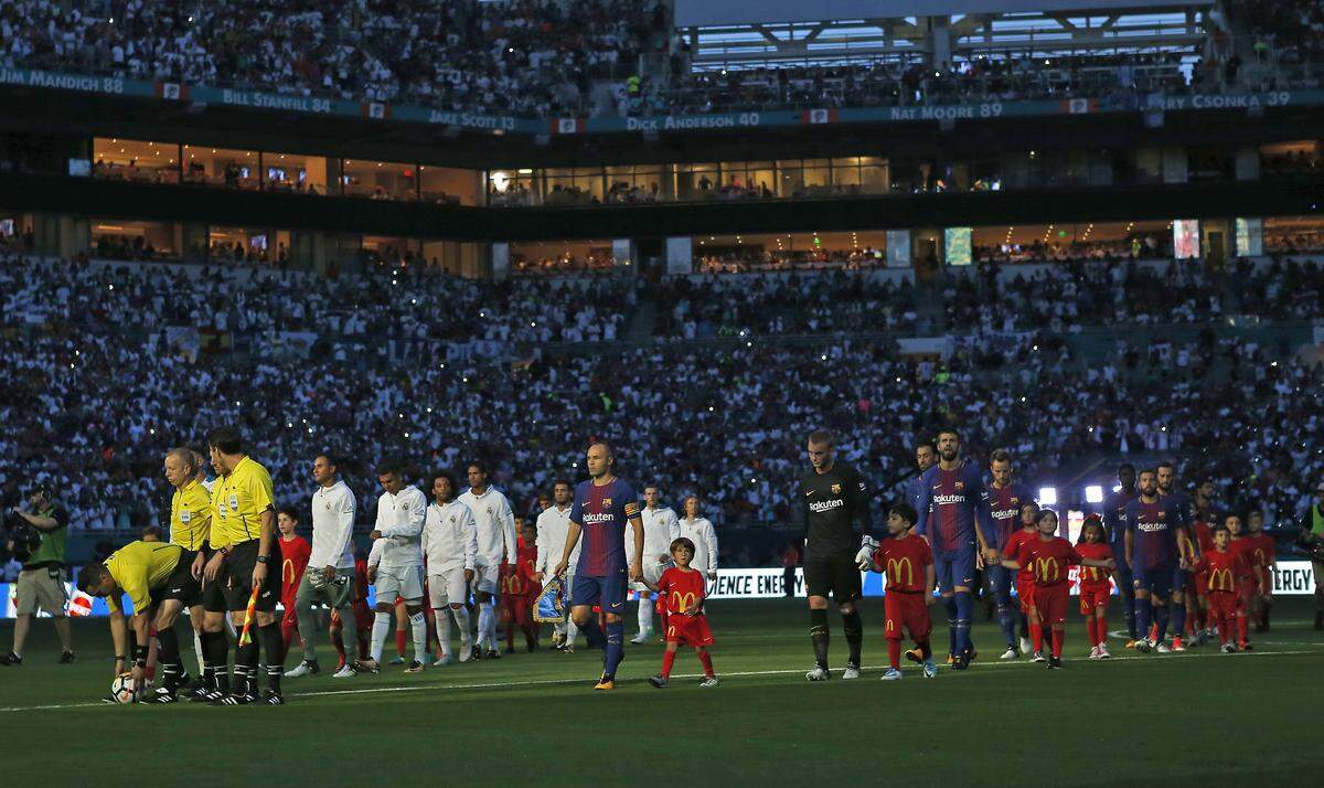 Teams walk into the field before the start of ''El Clasico Miami'' Barcelona-Real Madrid match as part of the International Champions Cup on Saturday, July 29, 2017, at Hard Rock Stadium in Miami Gardens. The sold-out game is eligible for a $750,000 bonus from Miami-Dade under a 2014 stadium deal that the county wants to expand in exchange for the Miami Dolphins moving its training facility from Davie to Miami Gardens.