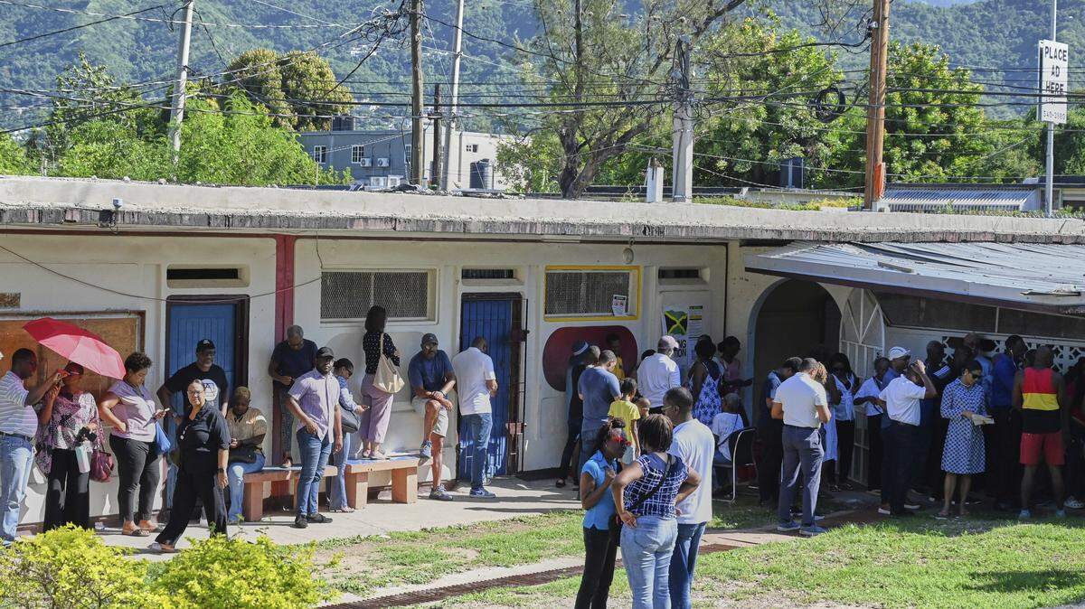 People stand in line to vote at a polling station during general elections in Kingston, Jamaica, Wednesday, Sept. 3, 2025.