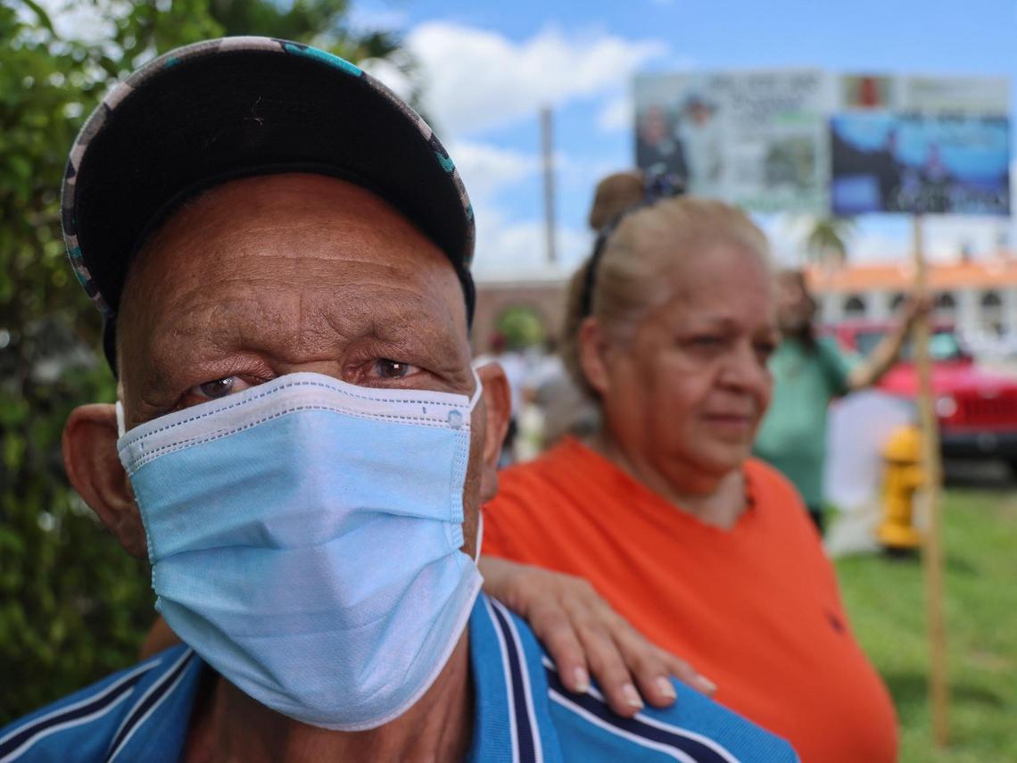 Santos Varela, 71, and Yolanda López, 62, join fellow residents of Li’l Abner Mobile Home Park in protest against their pending eviction on May 19, 2025, in Sweetwater, Florida.