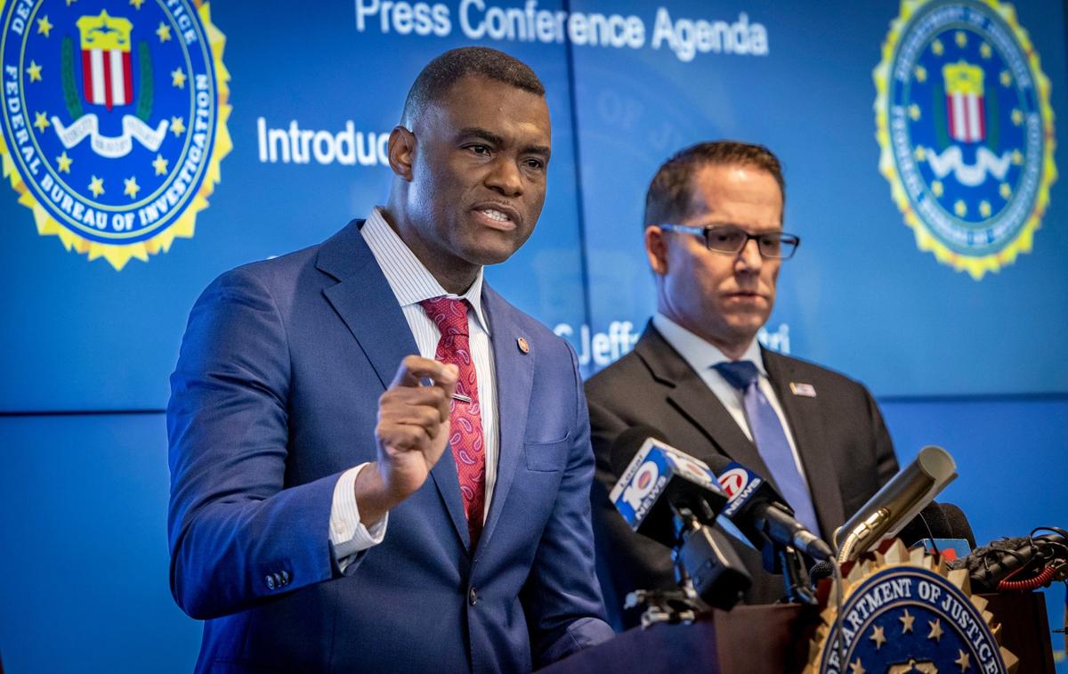Miramar, Florida, July 17, 2024 - U.S. Attorney for the Southern District of Florida Markenzy Lapointe, left, talks to reporters as FBI Miami Special Agent in Charge Jeffrey B. Veltri, right, stands by during a press conference to address developments in the Sergio Pino murder for hire investigation.