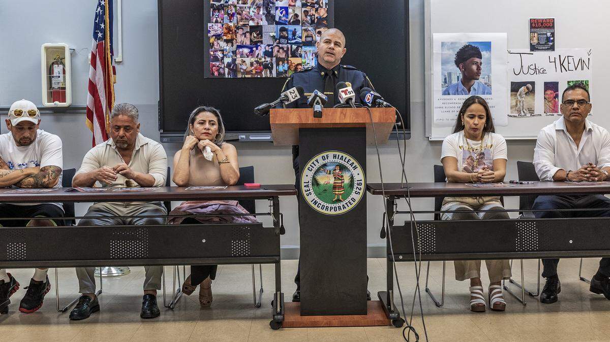 Family members of Cristian Rolando Contreras (on the left) and Kevin Ramirez join Hialeah Police Lt. Eddie Rodriguez during a public plea for Information in the unsolved murders of Kevin and Cristian, who were found shot to death inside an apartment in Hialeah last July, on Thursday Nov. 20, 2025.