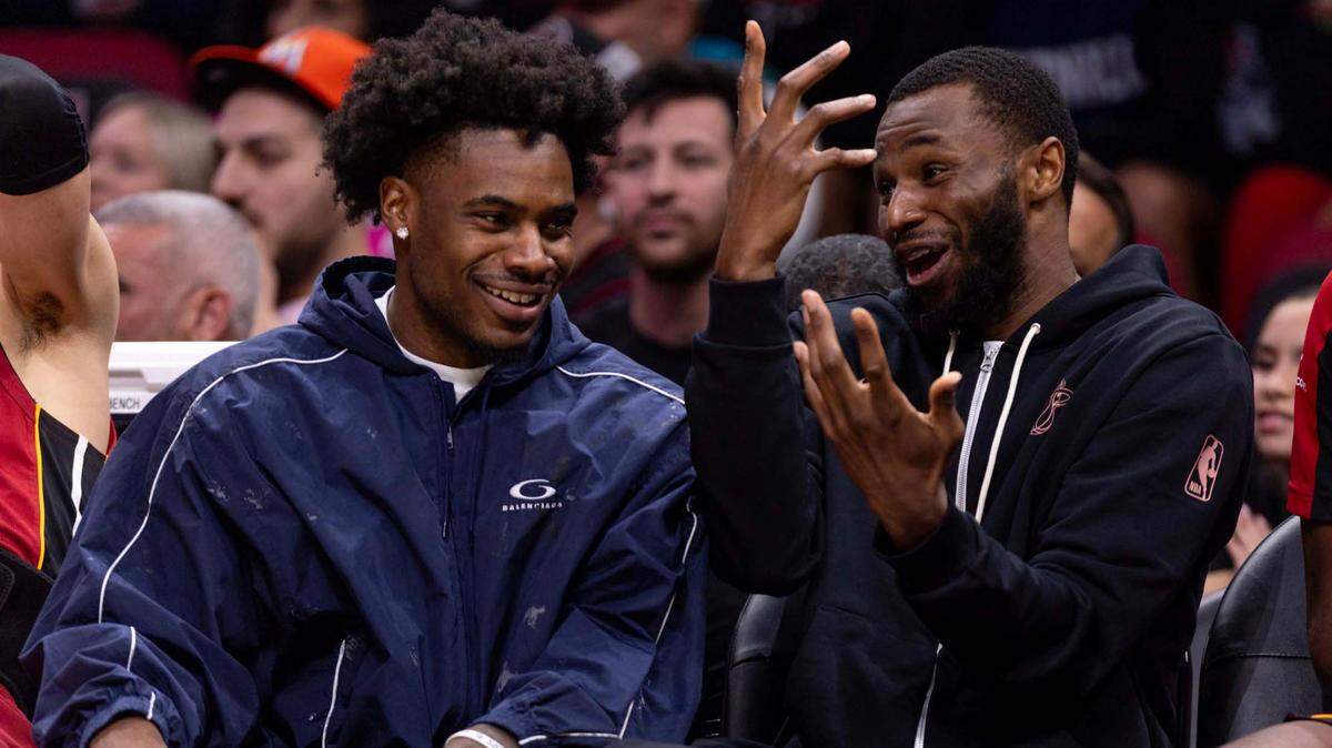 Miami Heat guard Davion Mitchell (45) and forward Andrew Wiggins (22) react on the bench while injured during the second half of an NBA game against the Washington Wizards at Kaseya Center on March 3, 2025, in Miami.