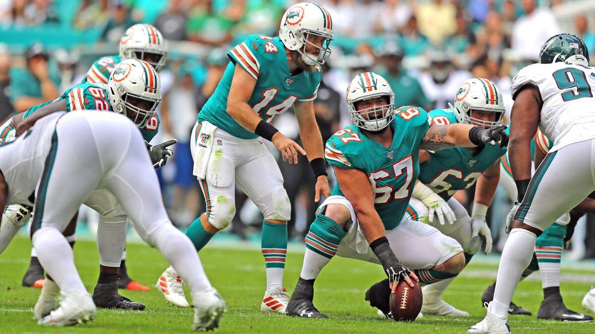 Miami Dolphins quarterback Ryan Fitzpatrick (14) with center Daniel Kilgore (67) at the line of scrimmage in the fourth quarter as the Miami Dolphins host the Philadelphia Eagles at Hard Rock Stadium in Miami Gardens on Thursday, November 1, 2019.