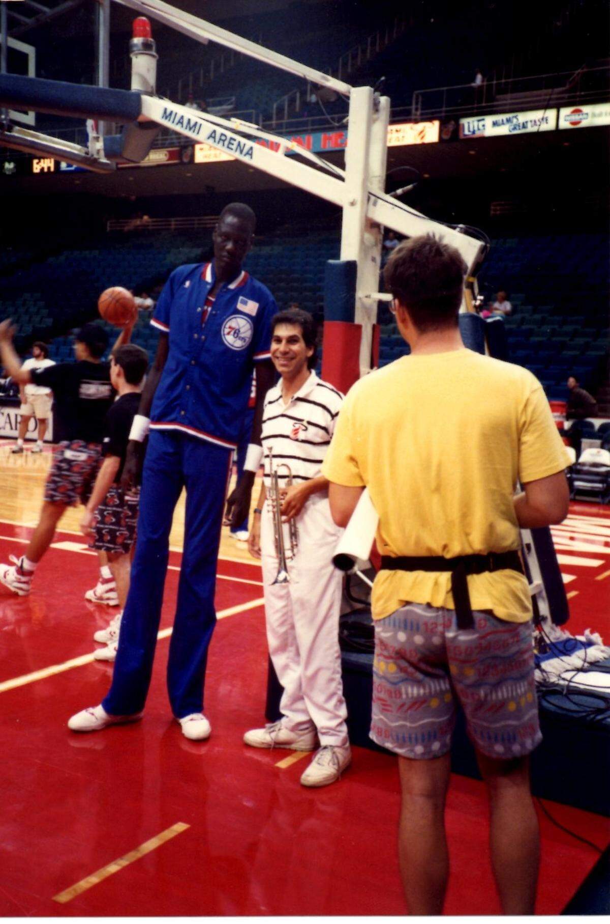 Miami Heat band trumpet player Michael Suman next to 7-foot-6-inch Manute Bol.