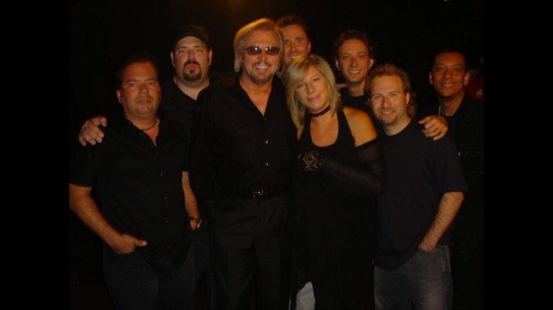 Barry Gibb (center) co-wrote and produced songs for Barbra Streisand’s 2005 album, “Guilty Pleasures.” The two pose with musicians from Gibb’s band, including guitarist Dan Warner (top, left) of Plantation, Florida.