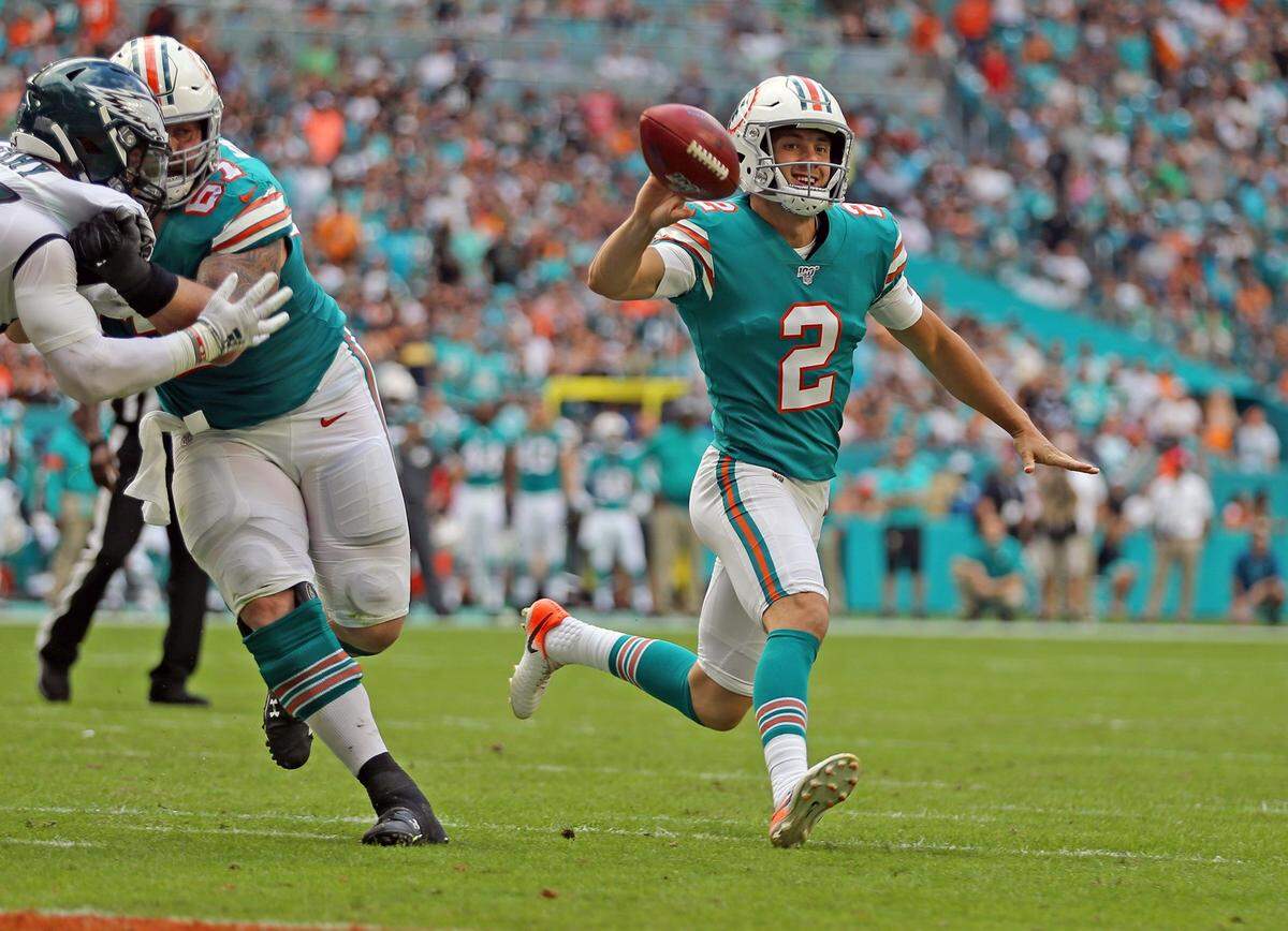 Miami Dolphins punter Matt Haack (2) tosses the ball to kicker Jason Sanders to score late in the second quarter as they play the Philadelphia Eagles at Hard Rock Stadium in Miami Gardens, Florida, Sunday, December, 1, 2019.