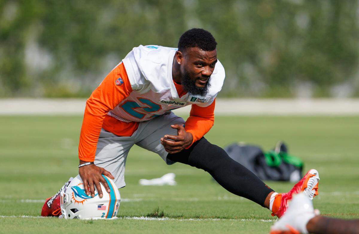 Miami Dolphins running back Jeff Wilson Jr. (23) stretches on the field during practice at Baptist Health Training Complex in Hard Rock Stadium on Wednesday, November 30, 2022 in Miami Gardens, Florida.