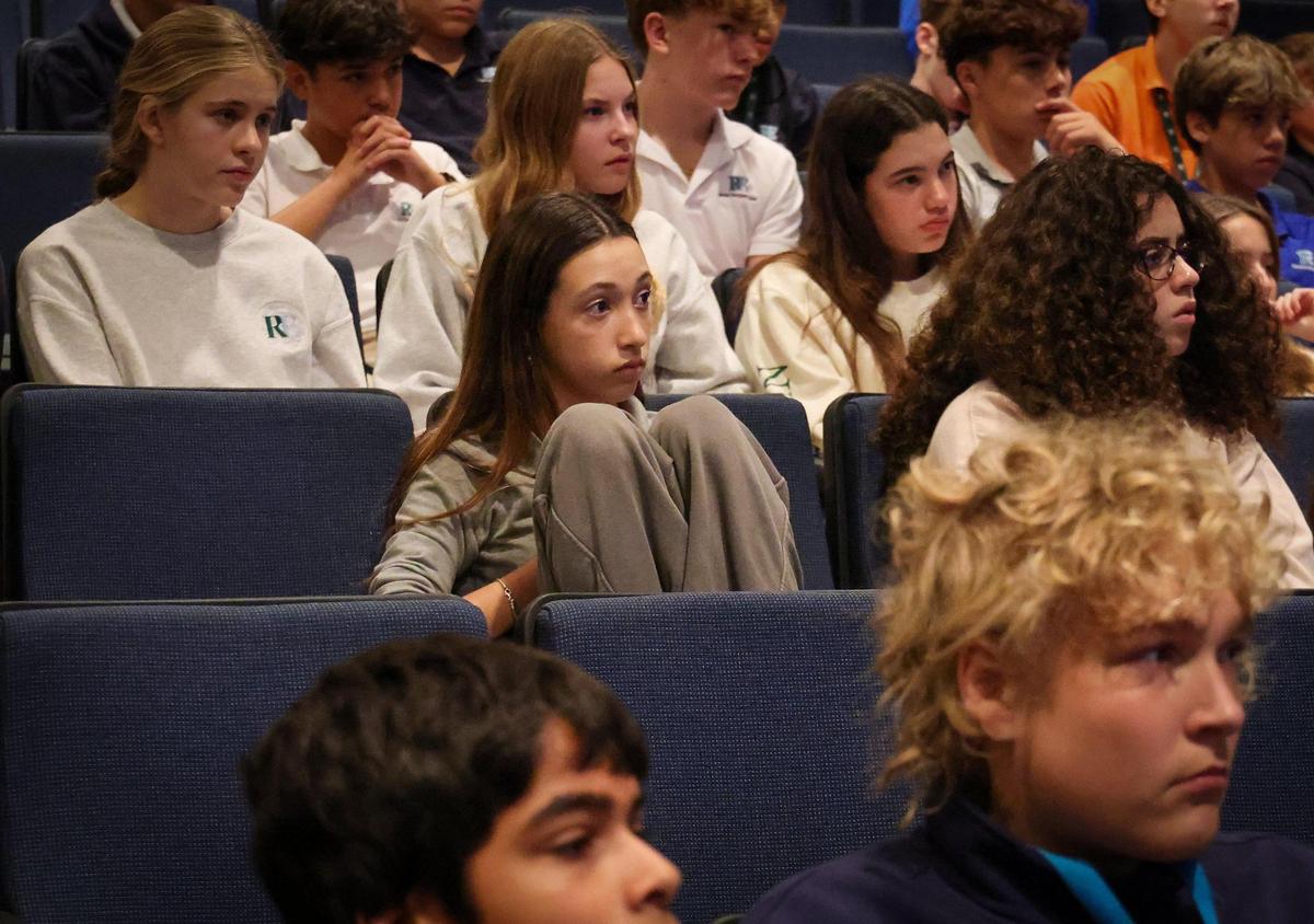 Ransom Everglades 8th graders Luna Mercadel, center, listens closely as Holocaust survivor Allan Hall recounts his experience as young child hiding in different locations to escape the Nazis. The Holocaust Memorial Miami Beach and 3GMiami organized third and fourth-generation relatives of survivors to speak to students on International Holocaust Remembrance Day.