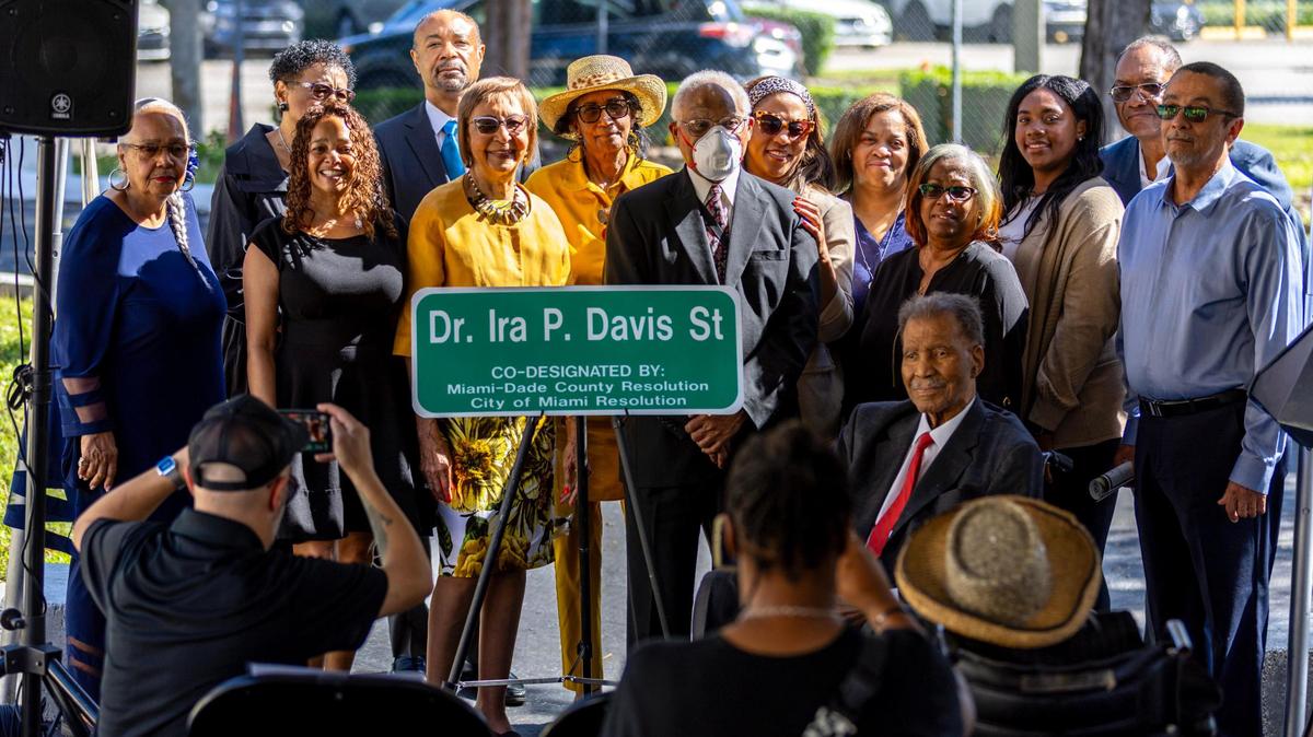 The family of civil rights advocate Dr. Ira P Davis gathers around the new street sign renamed to ‘Dr. Ira P, Davis St’ during a ceremony at the Historic Black Police Precinct & Courthouse in Miami, Florida, on Friday, November 17, 2023. Northwest 16th Street between Second and Third Avenue was renamed “Dr. Ira P. Davis Street.”
