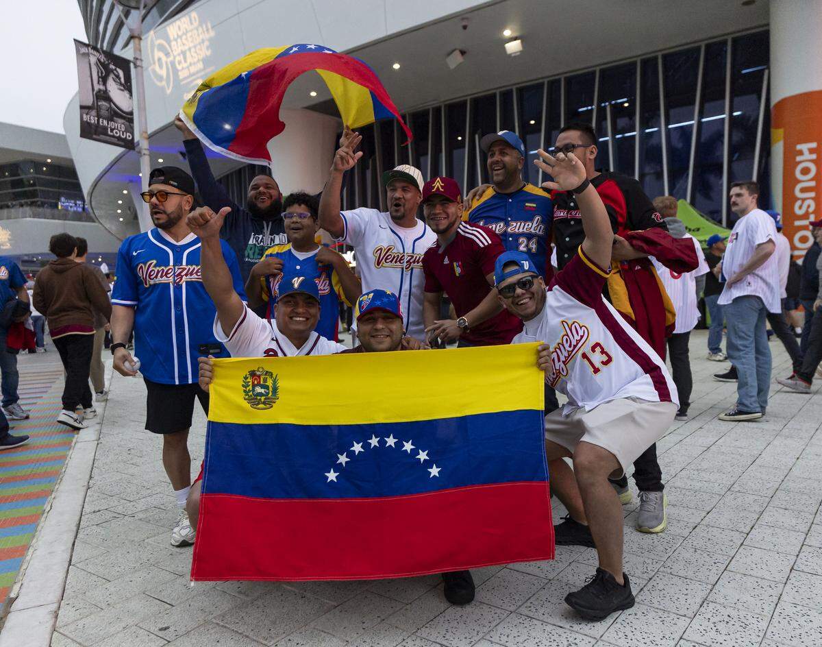 Venezuela fans gather for a photo before the start of their team’s World Baseball Classic final game against the United States at loanDepot Park on Tuesday, March 17, 2026, in Miami, Fla.
