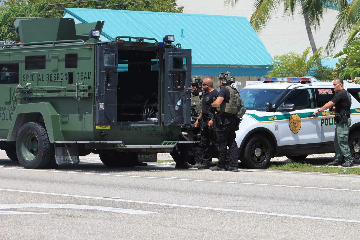 Members of the Miami-Dade County Police special response team gather outside of the Executive Bay Club townhouses in Islamorada Thursday, May 7, 2020, where police say a 17-year-old boy fatally stabbed his brother and severely wounded his father.