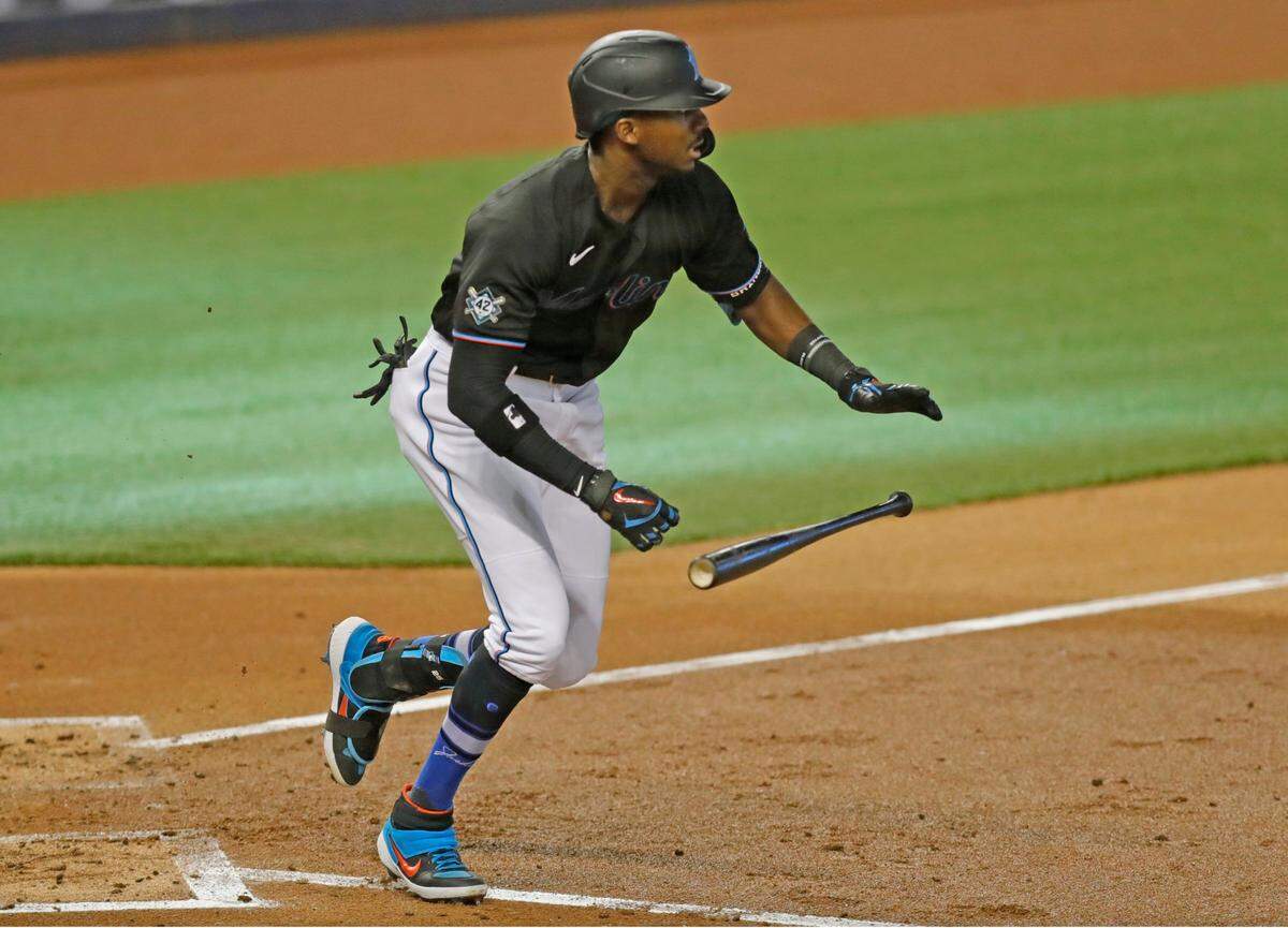 Miami Marlins center fielder Lewis Brinson (25) singles in the third inning as the Miami Marlins host the Tampa Bay Rays at Marlins Park in Miami on Saturday, August 29, 2020.