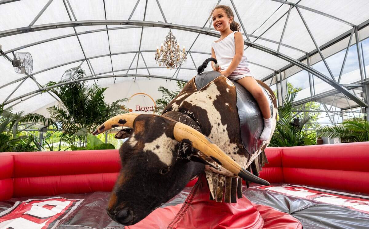 Hannah Serrat,6, rides the mechanical bull at Royd's in Miami, Fla., Sunday, May 31, 2026