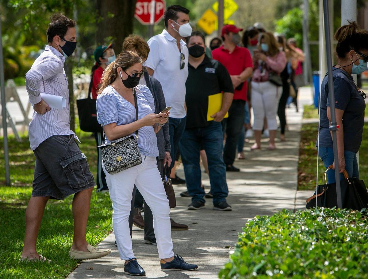 Miami, Florida, March 11, 2021 - People line up to get into the gymnasium at the Miami Springs Community Center, 1401 Westward Drive, Miami Springs. Two new satellite federal vaccination sites opened on Thursday. The other site is in North Miami Beach.