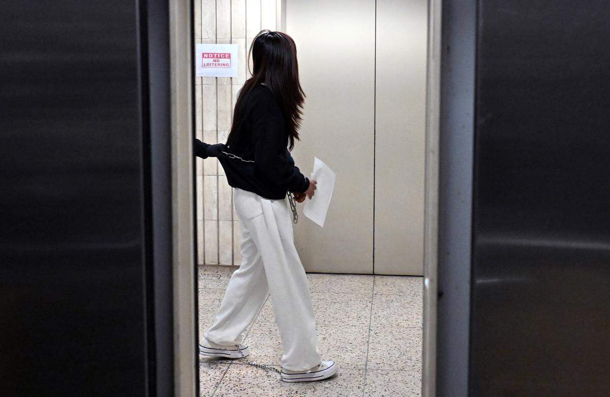 A woman is led in shackles on the 10th floor of the Jacob K. Javits Federal Building in New York on Oct. 2, 2025, where migrants are held in detention. There is now a legal injunction requiring ICE to house only a limited number of people on the floor. Elected officials are denied access.