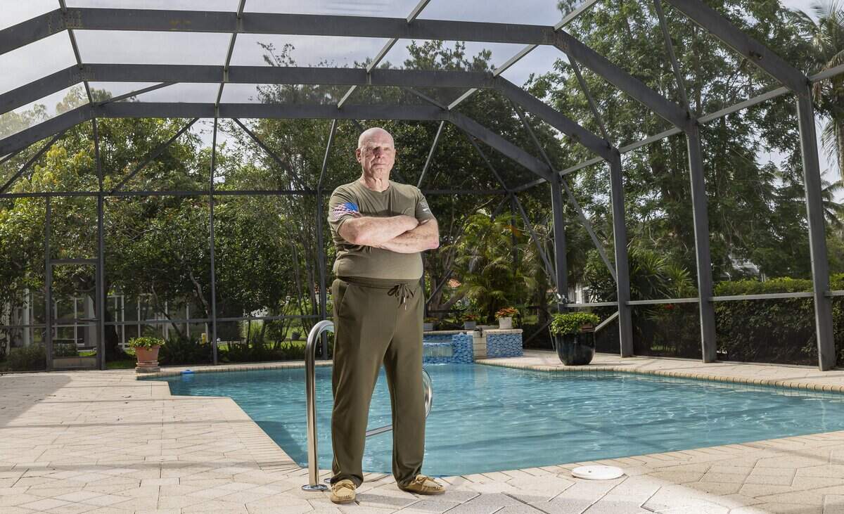 James Weidener is photographed by his pool enclosure on Saturday, May 30, 2026, in Coral Springs, Fla. His homeowners insurance paid to replace the enclosure after it was damaged during Hurricane Wilma. Weidener opted out of homeowners insurance for nine years because of high costs but resumed coverage a couple of years ago.