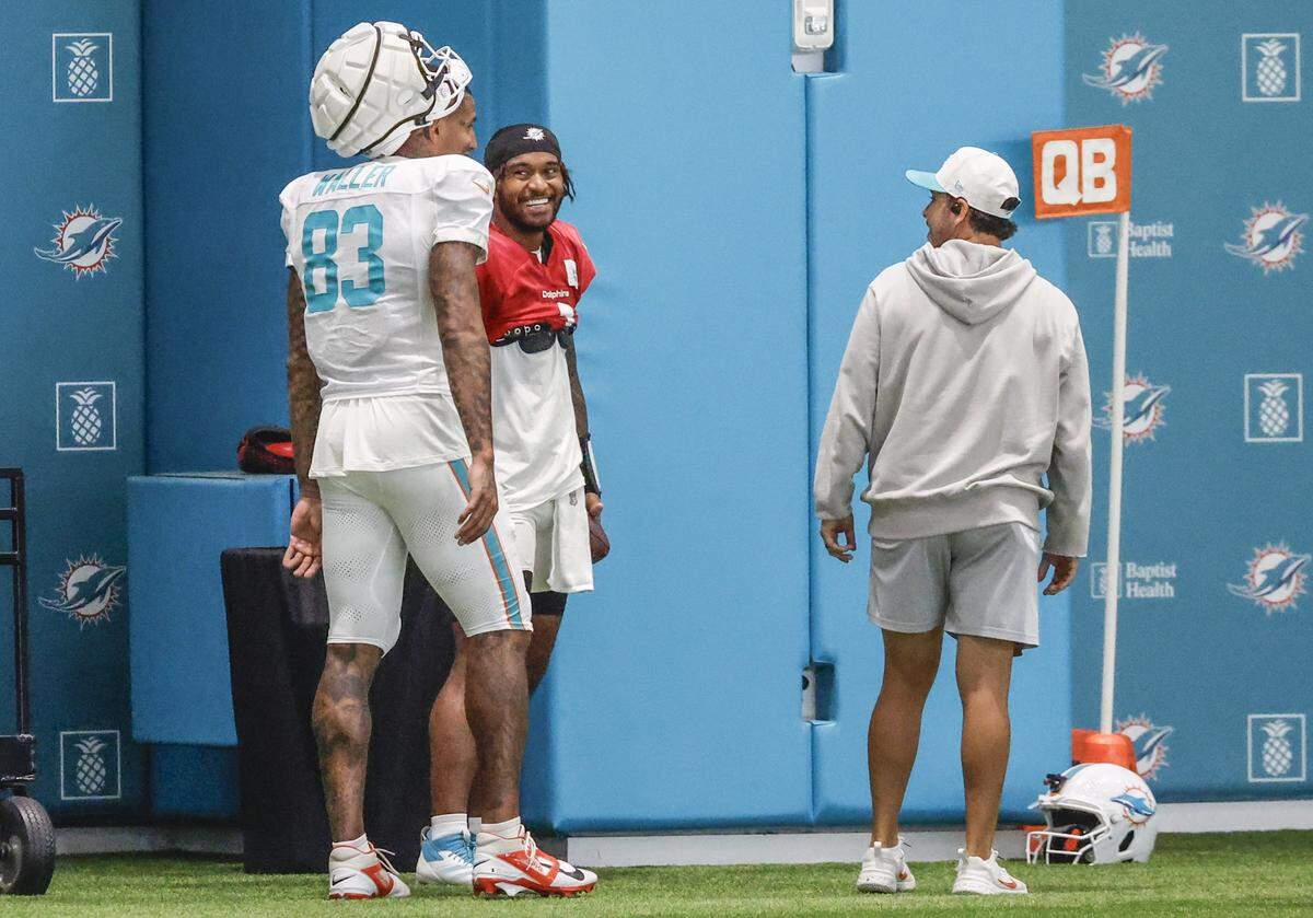 Miami Dolphins quarterback Tua Tagovailoa (1) interacts with tight end Darren Waller (83) during practice at the Miami Dolphins Training Camp in Miami Gardens, Florida, on Wednesday, August 20, 2025.