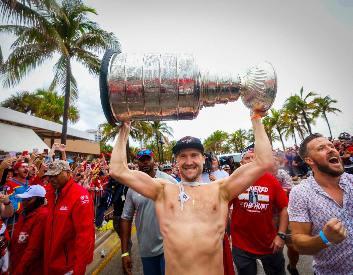 Florida Panthers goaltender Sergei Bobrovsky  lifts the Stanley Cup as fans cheers during the Florida Panthers victory parade before the Stanley Cup victory parade at Fort Lauderdale Beach on Tuesday, June 30, 2024 in Fort Lauderdale.&nbsp;