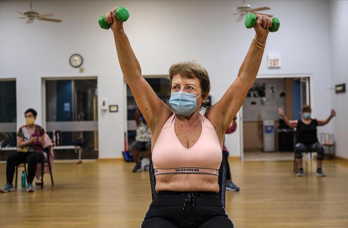 Elma Hamblet Bastien, center, works with weights during the Silver Sneakers fitness classes in 2020 at the Alper Jewish Community Center in Kendall, Florida. Many Medicare Advantage plans include Silver Sneakers fitness classes.