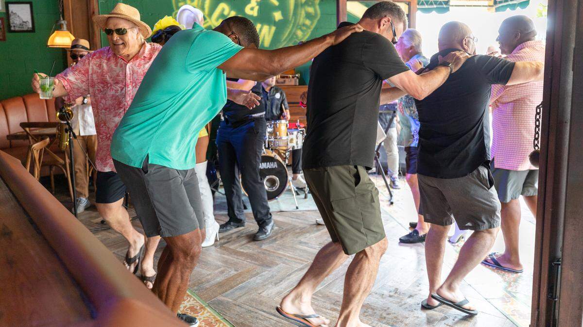 Terry Bradshaw (left) and other former NFL stars doing the conga line at Ball & Chain as part of a Fox Sports Super Bowl LIV promo.