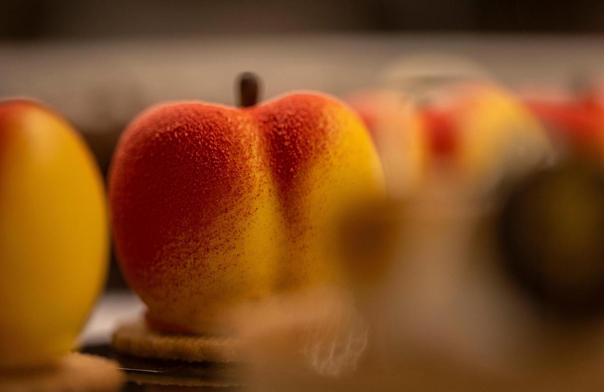 Peach mousse pastries on display at the counter of L’Artisane Creative Bakery in Coral Gables