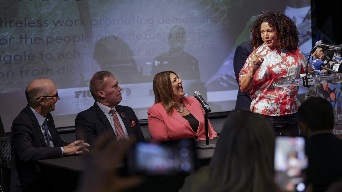 Maria Teresa Morin, coordinator of VENTE USA and close confidante of Venezuelan opposition leader María Corina Machado, looks towards Kenneth A. Jessell, former president of FIU, left, David A. Armstrong, president of St. Thomas University, and Madeline Pumariega, president of Miami Dade College.  The American Museum of the Cuban Diaspora, led by President Marcell Felipe, held a press conference celebrating Machado’s winning the Nobel Peace Prize. 
