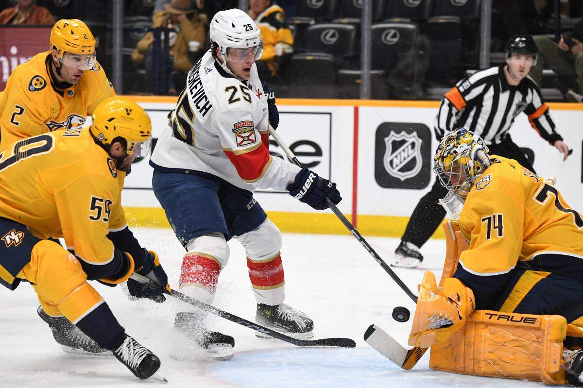 Jan 22, 2024; Nashville, Tennessee, USA; Florida Panthers right wing Mackie Samoskevich (25) has a shot blocked by Nashville Predators goaltender Juuse Saros (74) during the second period at Bridgestone Arena.