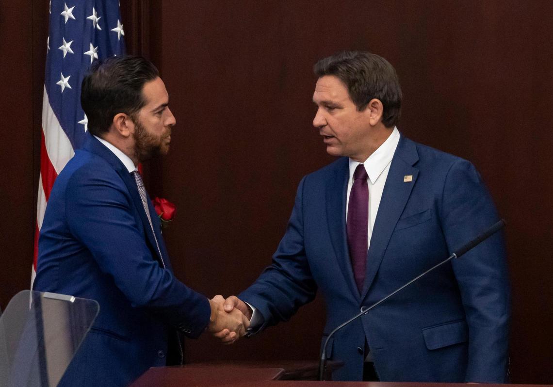 Florida Gov. Ron DeSantis shakes hands with Florida House Speaker Daniel Perez, R-Miami, after delivering his State of the State during the first day of the legislative session at the Florida State Capitol on Tuesday, March 4, 2025, in Tallahassee, Fla.