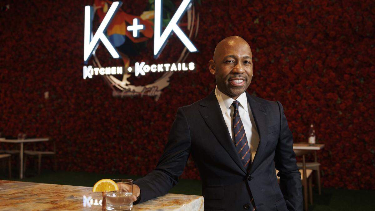 Owner Kevin Kelley in front of the famous Rose Wall at his new restaurant, Kitchen + Kocktails by Kevin Kelley in Wynwood.
