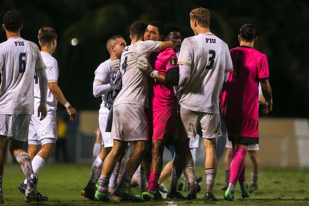 FIU Panthers goalkeeper Matt Levy (28) celebrates with defender David Garcia (4) after winning an NCAA soccer tournament game against New Hampshire at FIU Soccer Stadium at Florida International University in Miami, Florida, Sunday, November 20, 2022.